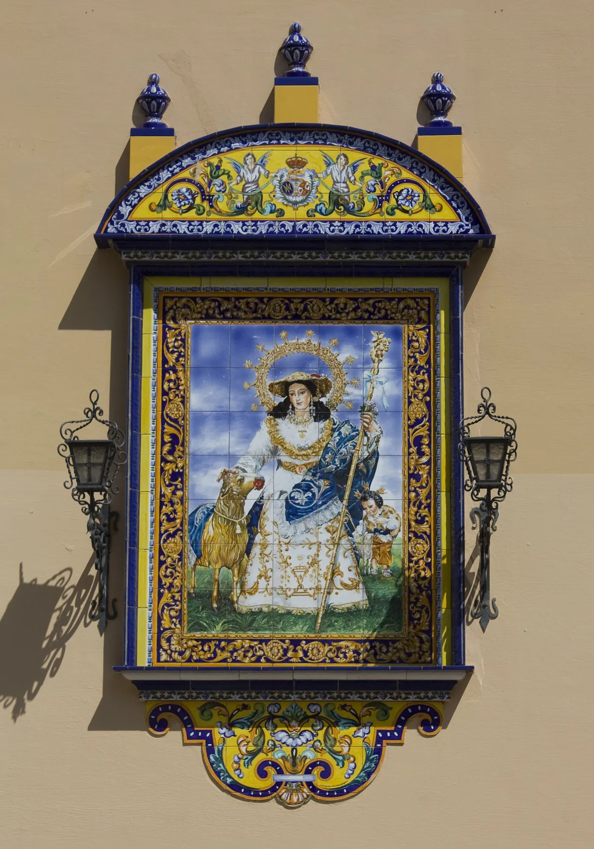 A ceramic panel showing the Virgin and Child in a decorated frame on the wall of the Church of Santa Ana